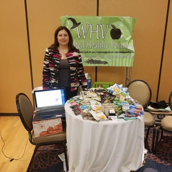 Tina Paine at a display table at the Health and Wellness Show
